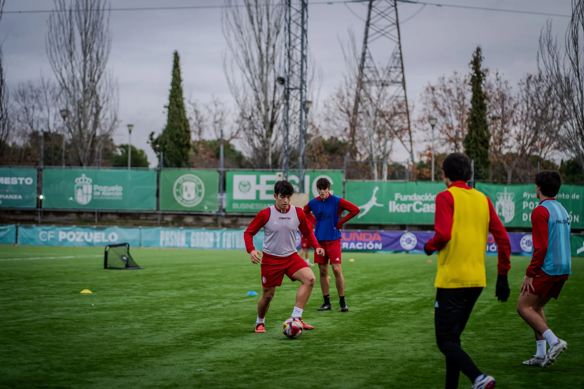 Players competing for the ball during a match on the campus pitch